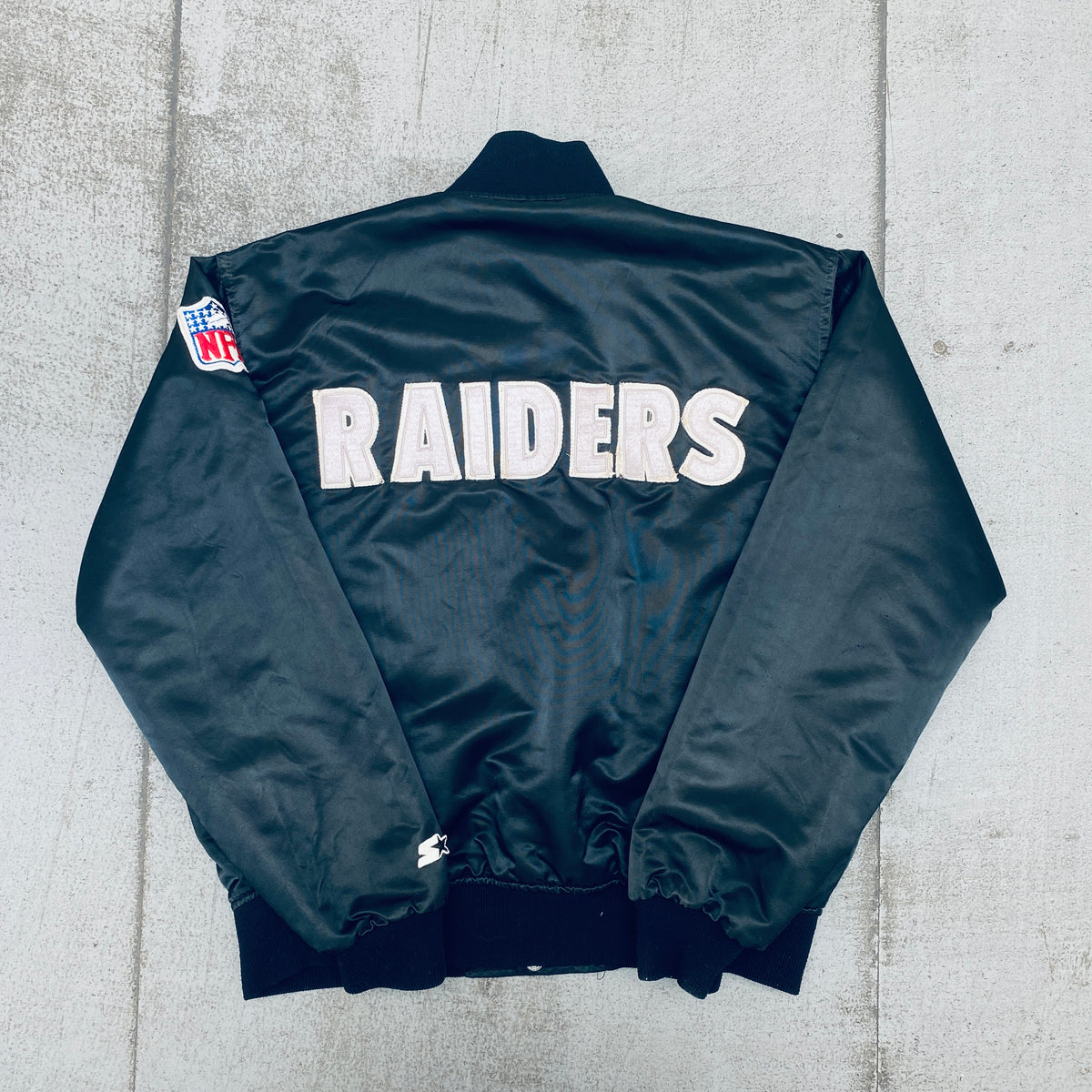 Los Angeles Raiders: 1980's Satin Reverse Spellout Proline Starter 