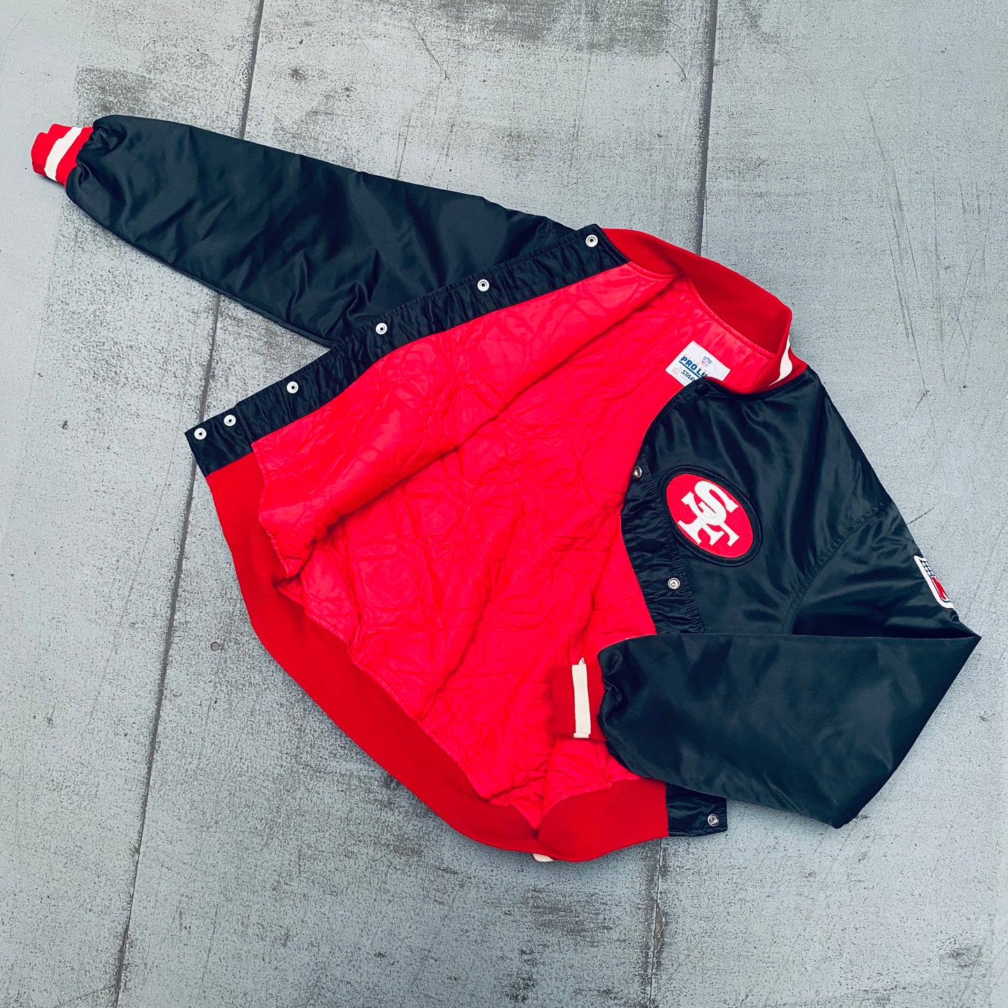 San Francisco 49ers: 1980's Blackout Satin Reverse Spellout Proline Starter Bomber Jacket (L)