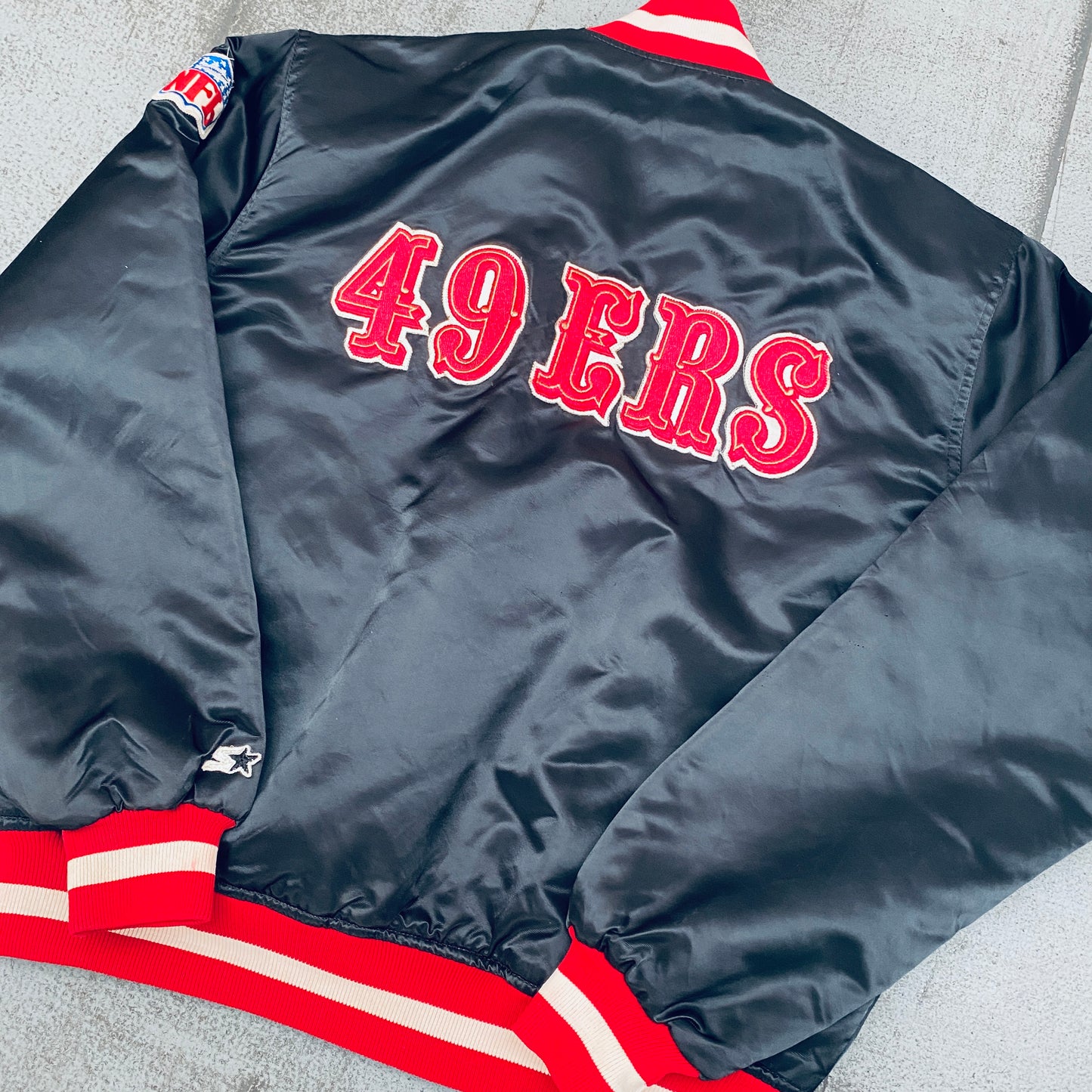 San Francisco 49ers: 1980's Blackout Satin Reverse Spellout Proline Starter Bomber Jacket (L)