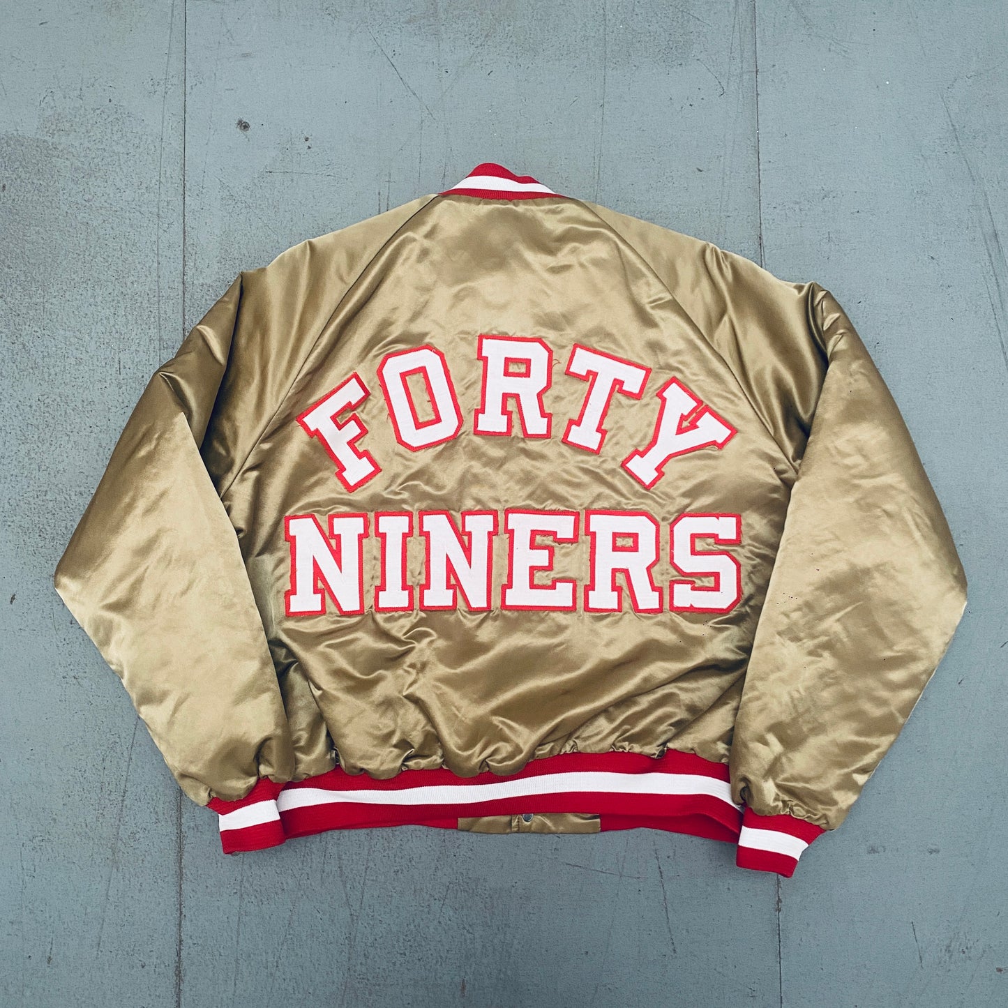 San Francisco 49ers: 1980's Chalk Line Satin Reverse Stitched Spellout Bomber Jacket (XL)