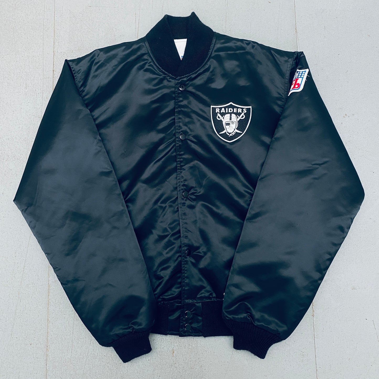 Los Angeles Raiders: 1980's Satin Reverse Spellout Proline Starter Bomber Jacket (XL)