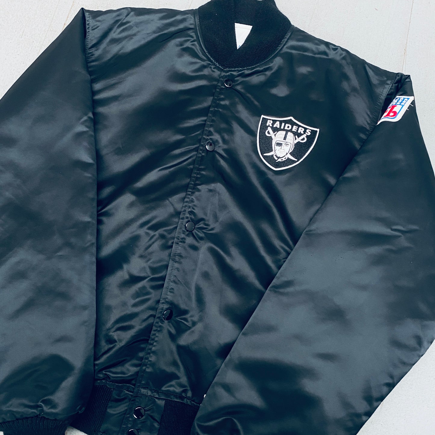 Los Angeles Raiders: 1980's Satin Reverse Spellout Proline Starter Bomber Jacket (XL)