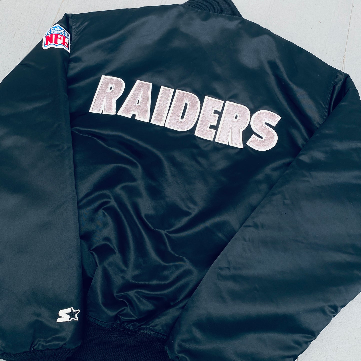 Los Angeles Raiders: 1980's Satin Reverse Spellout Proline Starter Bomber Jacket (XL)